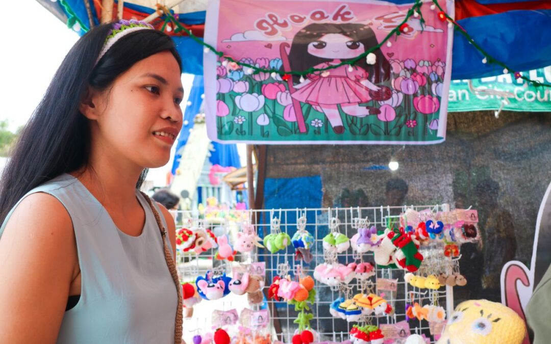 Local crocheting artist Hannah Alferez showcases handcrafted crochet products at the Christmas in the Capitol Bazaar